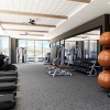 floor-to-ceiling windows surround large fitness center